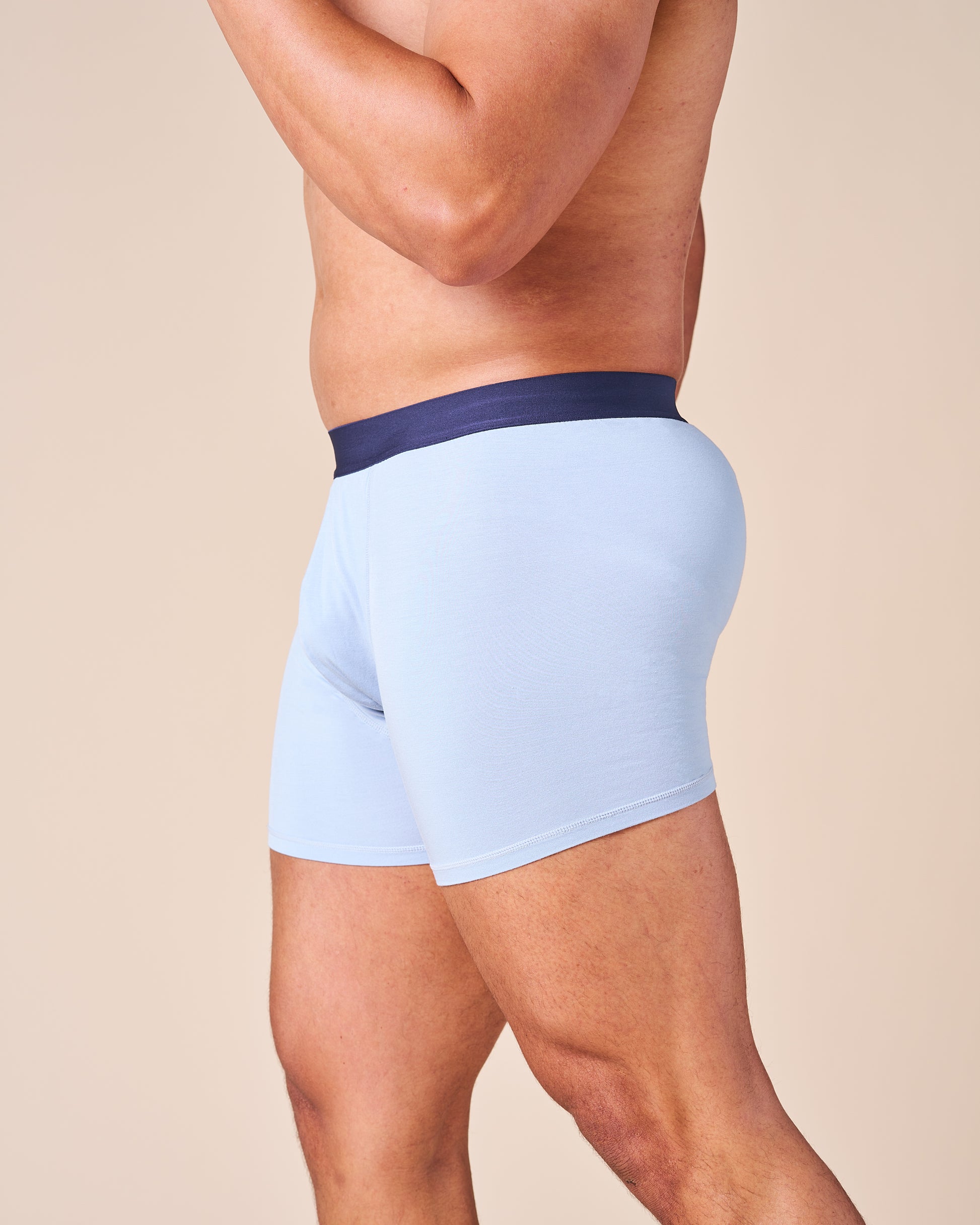 Side view of a male model wearing the comfortable and supportive light blue Fruitful Boxer